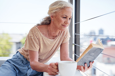 Buy stock photo Senior woman, reading book and relax with coffee on sofa for learning, knowledge or comfortable on balcony. Caffeine, story and elderly person with hot beverage for hobby, literature or peace in home