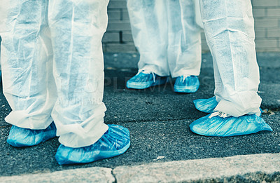 Buy stock photo Legs and feet of healthcare workers wearing protective gear or hazmat suits outdoors while cleaning. Closeup of a team of medical professionals meeting during the covid or coronavirus pandemic