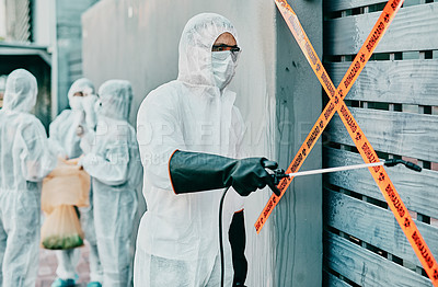 Buy stock photo Hazmat wearing medical and healthcare worker sanitizing and cleaning a quarantine and contamination site. Medical professional stopping the spread of a virus or infection of a building in the city