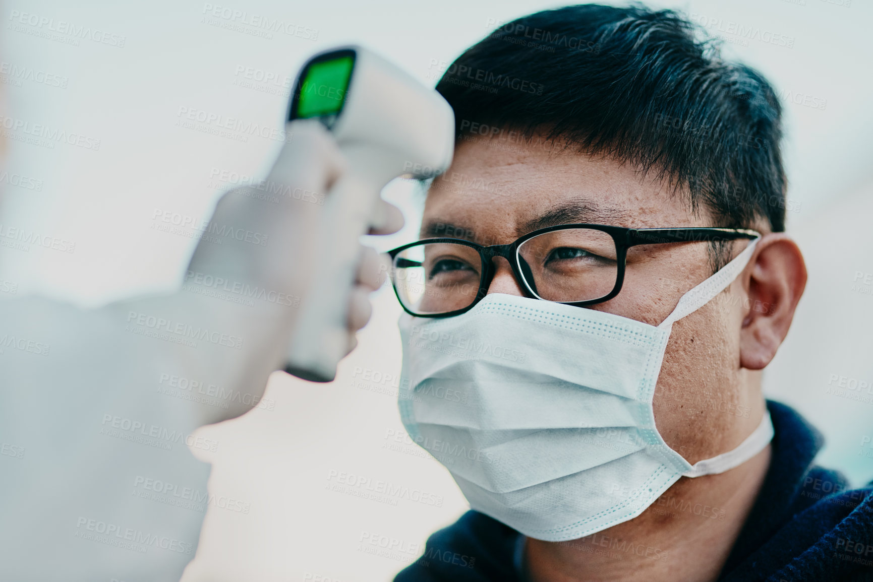 Buy stock photo Covid temperature scanning a man head or healthcare worker doing protocol, routine checkup of patient arriving at the airport or border. Traveling refugee or foreign man with face mask in quarantine