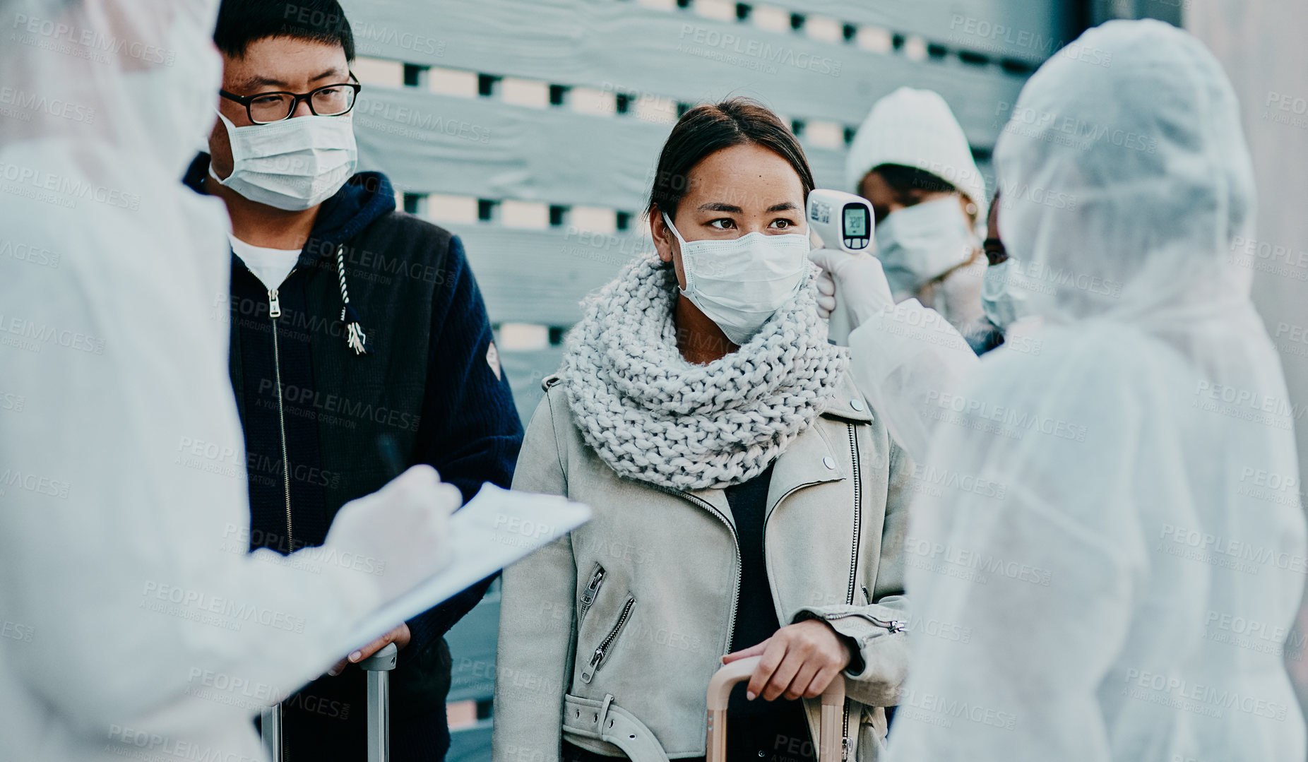 Buy stock photo Traveling woman getting a covid temperature scan at the border with medical security doing screening test for safety during pandemic. Foreign people or traveler arriving at an airport with face mask