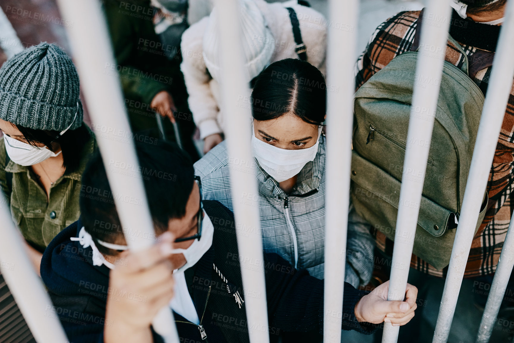 Buy stock photo Covid travel ban, lockdown or border control to prevent spread of pandemic virus, contagious disease or illness. Travelers in masks facing quarantine, abuse and discrimination behind locked gate 