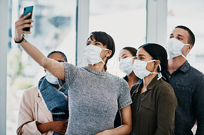 Buy stock photo Shot of a group of young people wearing masks and taking selfies at the airport