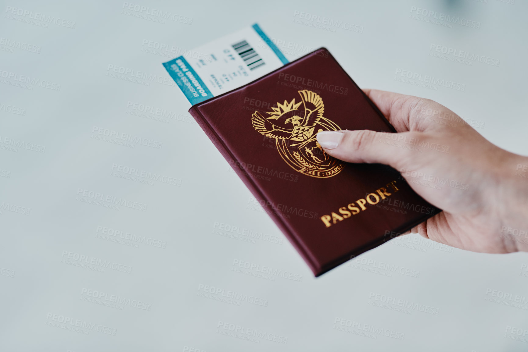Buy stock photo Cropped shot of a woman holding her passport and boarding pass in an airport