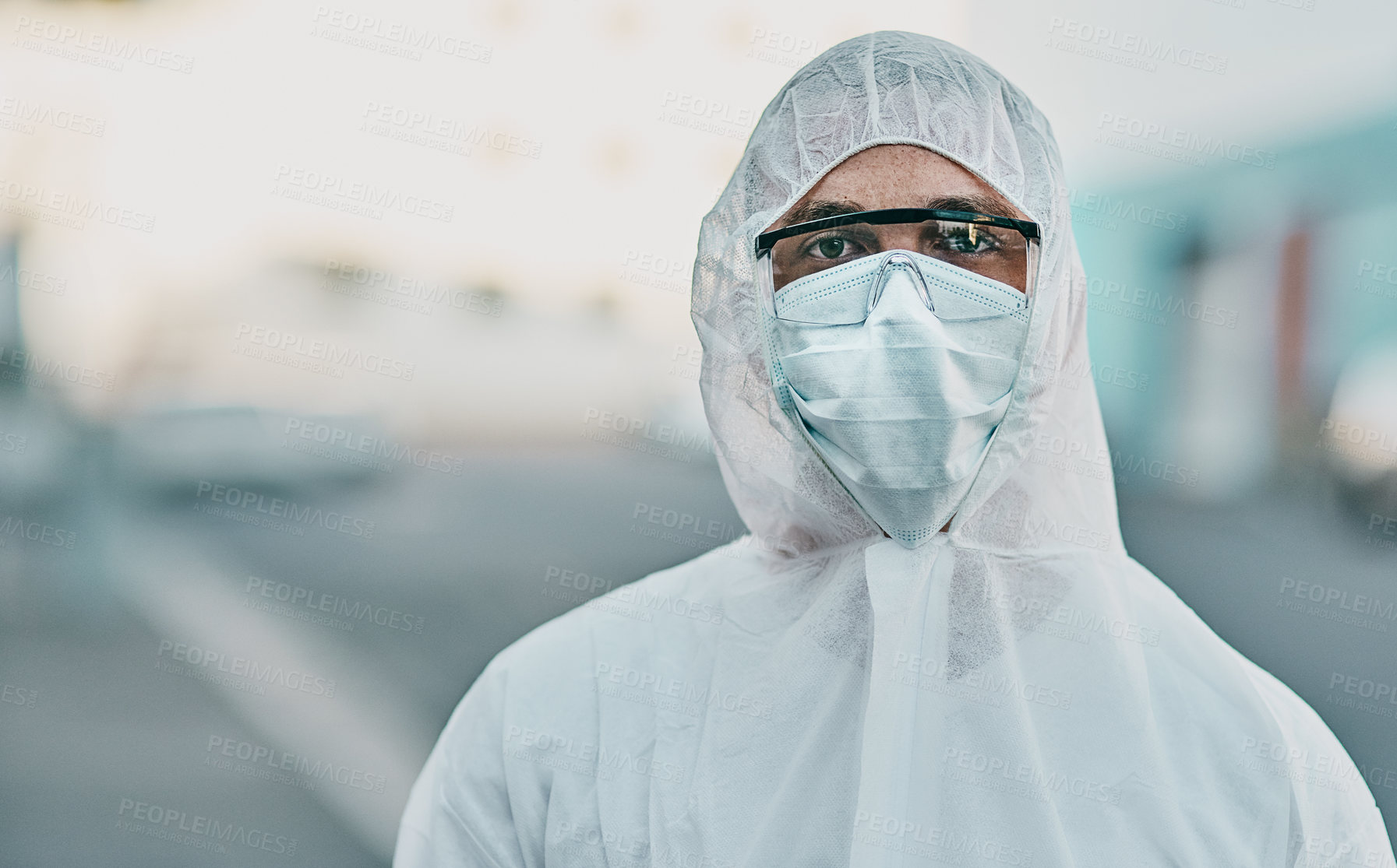 Buy stock photo Shot of a young man dressed in his protective gear before the decontamination process