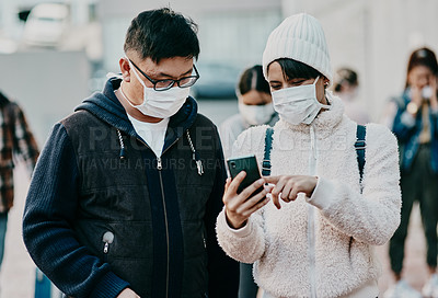 Buy stock photo People in covid face mask and phone searching information online looking at the news on travel ban restriction on social media while stranded at the border. Modern foreign traveling people at airport