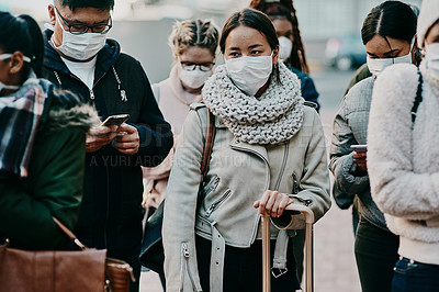 Buy stock photo Shot of a group of young people wearing masks while travelling in a foreign city