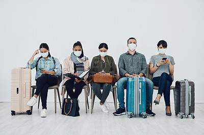 Buy stock photo Travel and tourism during the pandemic with passengers wearing masks and being safe in an airport waiting line. Group of people in a departure lounge, ready to board and complying with covid protocol