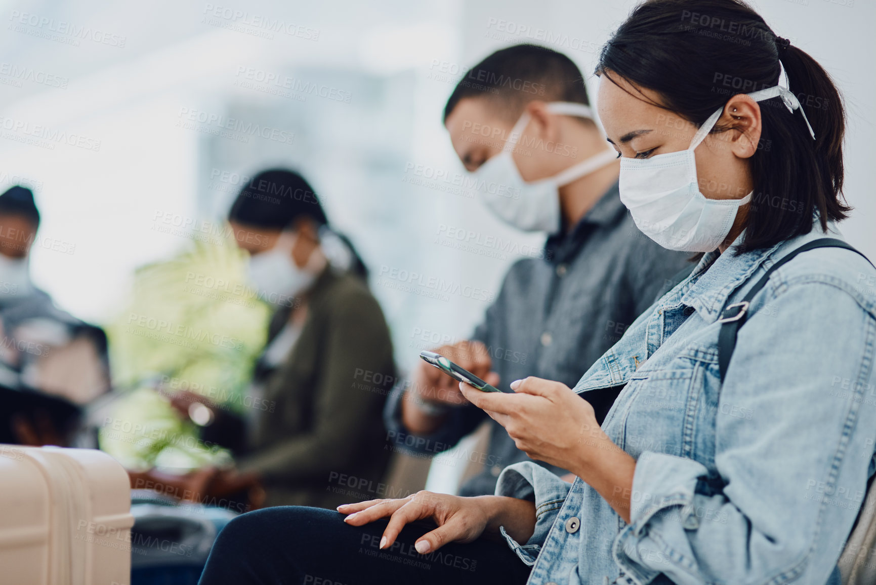 Buy stock photo Female tourist on phone traveling during covid at airport waiting for departure, wearing a mask for protection. For hygiene and healthcare security, follow corona virus social distance regulations.