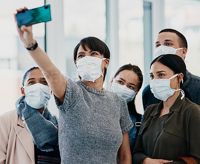 Buy stock photo Shot of a group of young people wearing masks and taking selfies at the airport
