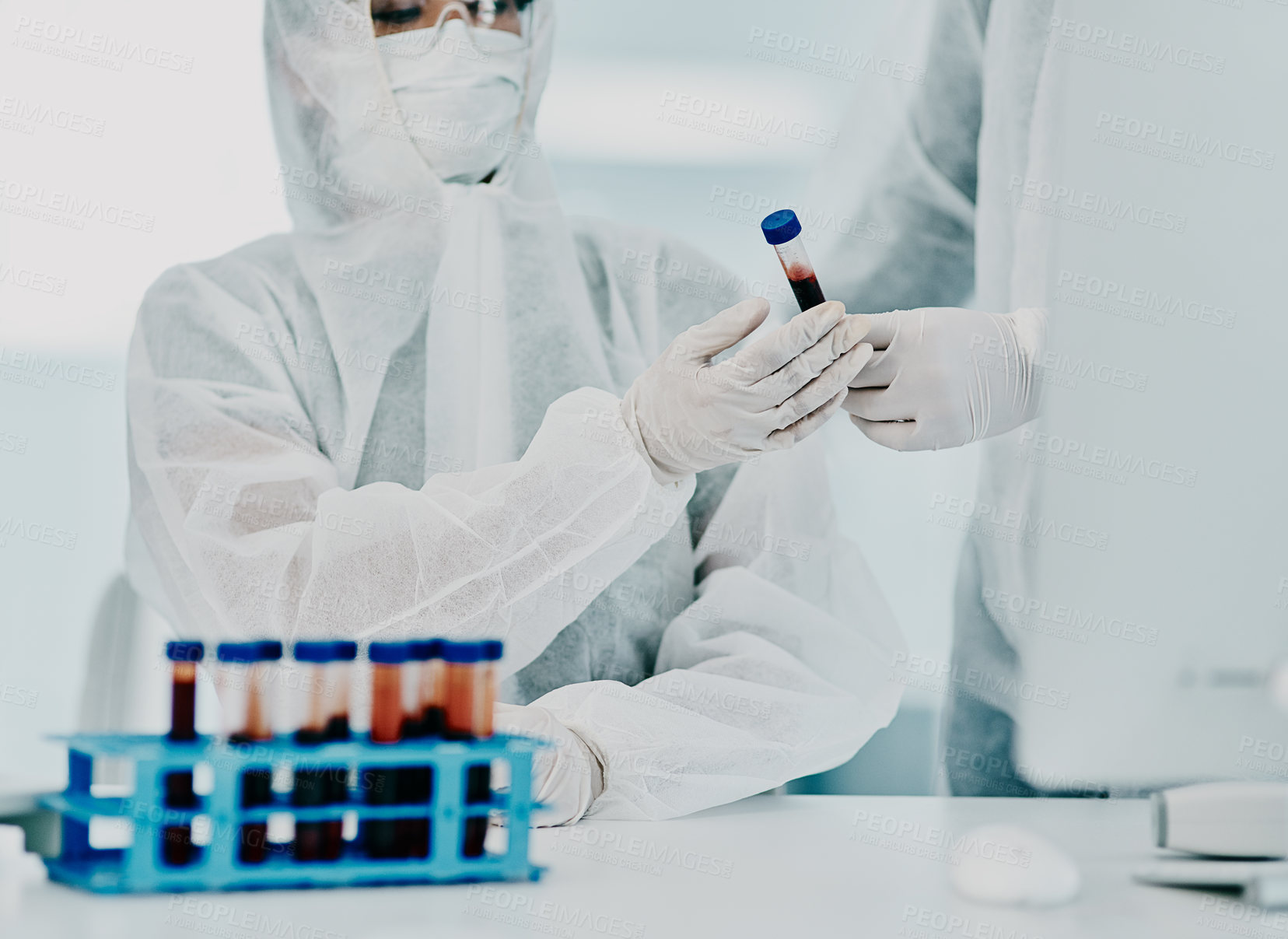 Buy stock photo Scientists testing covid blood sample with protective ppe to prevent spread of virus in hospital. Pair of doctors or medical workers wearing hazmat suits doing experimental research in lab.