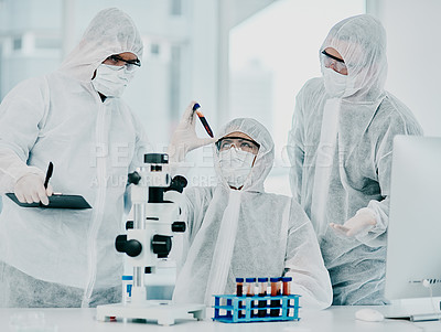 Buy stock photo Group of doctors and scientists conducting medical research on viruses dressed in hazmat suits, for coronavirus cure in the lab. Researchers conducting experiments and examining test tube