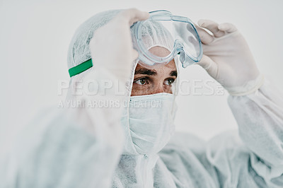 Buy stock photo Covid, pandemic and healthcare worker wearing protective ppe to prevent virus spread at a quarantine site or hospital. Closeup of a doctor or scientist wearing a hazmat suit and goggles for safety