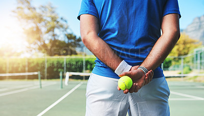 Buy stock photo Rearview shot of an unrecognizable male tennis player holding a tennis ball on a court outdoors