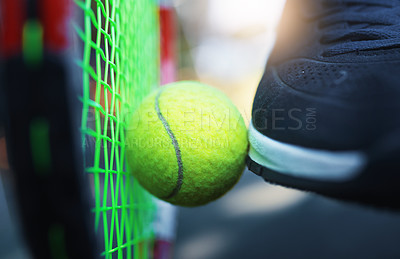 Buy stock photo Closeup shot of an unrecognizable tennis player kicking a tennis ball against a racket on a tennis court outdoors