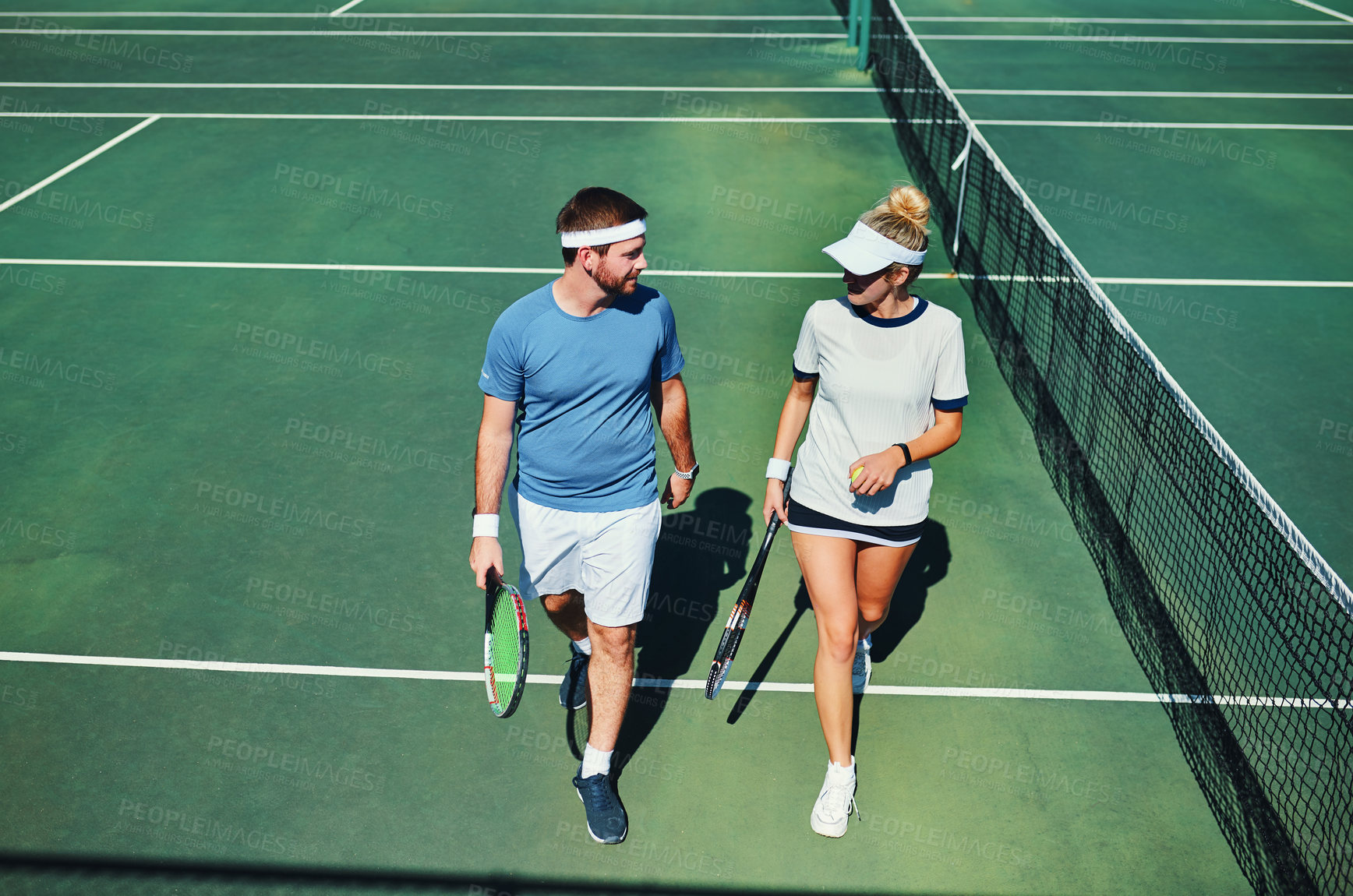 Buy stock photo Tennis, talking and above of couple on court for training, tournament match and game competition. Sports, athlete and man and woman with racket outdoors for exercise, workout and fitness for practice