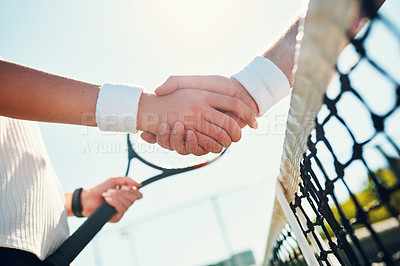 Buy stock photo Cropped shot of two unrecognizable tennis players shaking together outdoors on the court