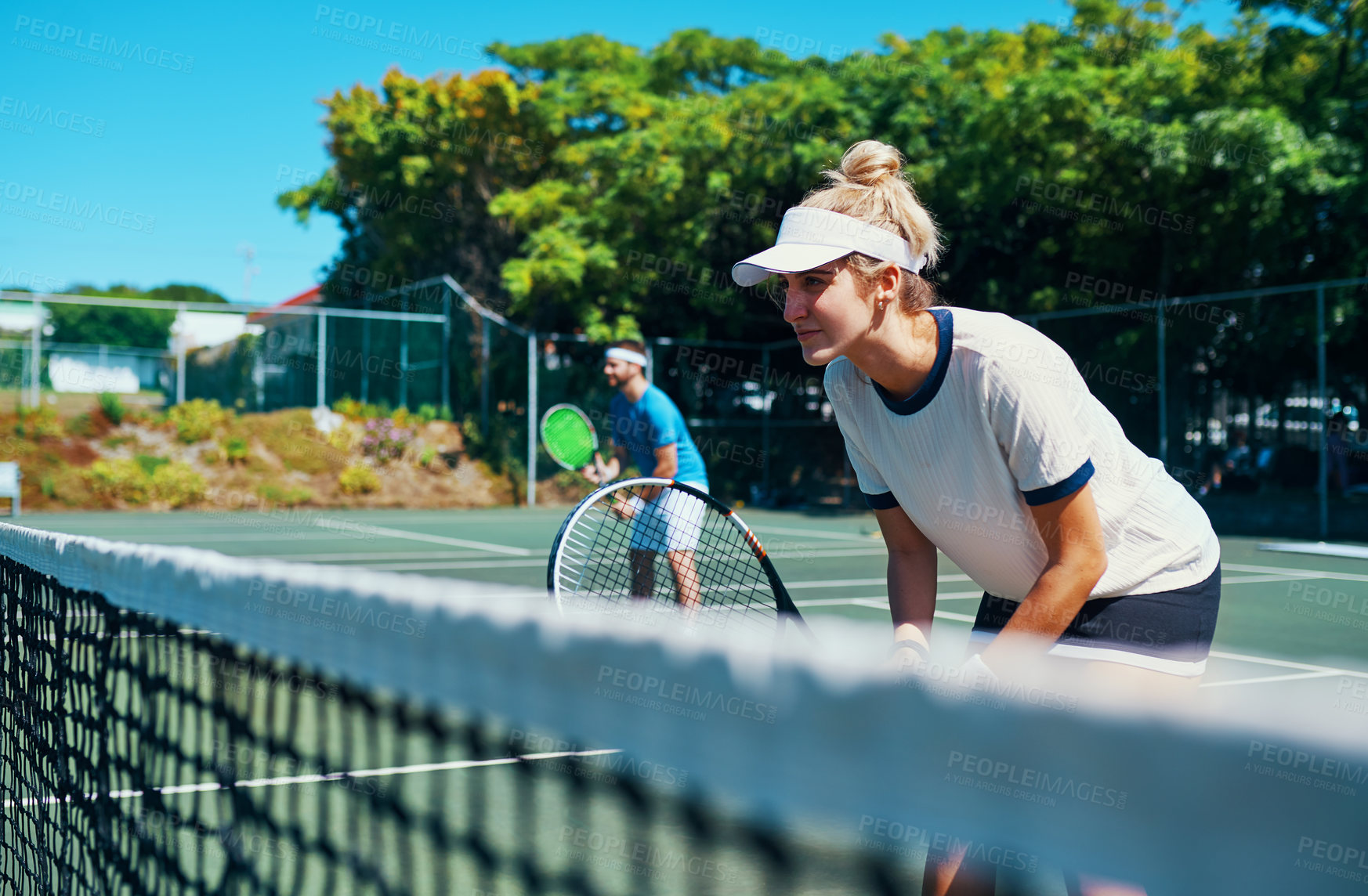 Buy stock photo Cropped shot of a mixed doubles tennis team playing together on a tennis court outdoors