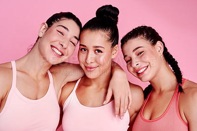 Buy stock photo Studio portrait of a group of sporty young women standing together against a pink background