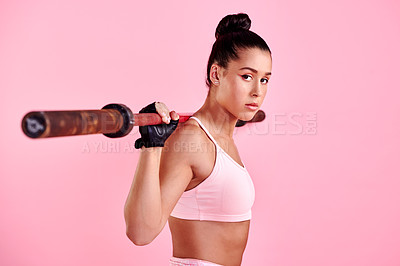 Buy stock photo Studio portrait of a sporty young woman exercising with a barbell against a pink background