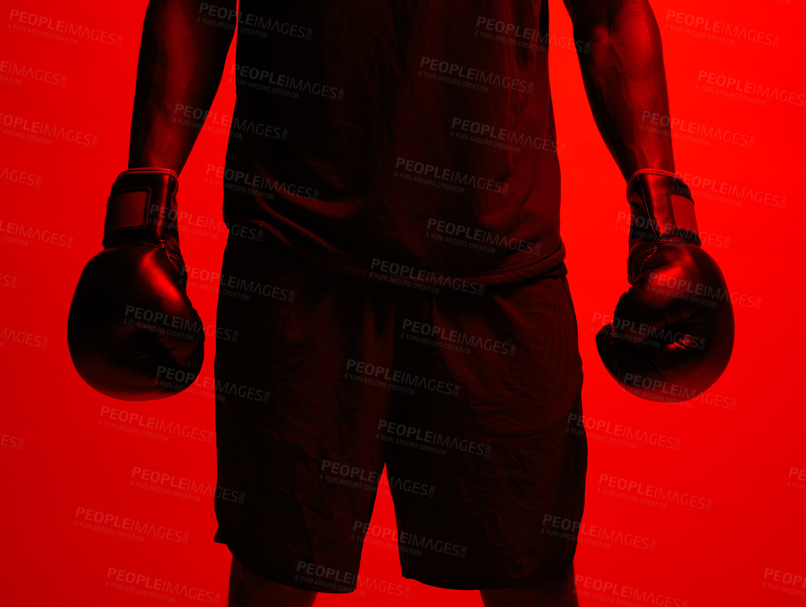 Buy stock photo Red filtered shot of a sportsman  wearing boxing gloves