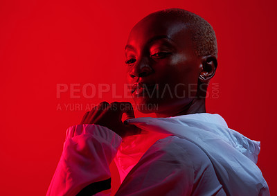 Buy stock photo Red filtered shot of a sporty young posing in the studio