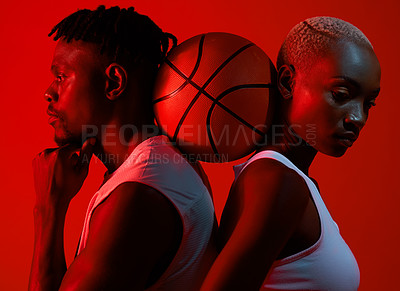 Buy stock photo Red filtered shot of a sporty young man and woman posing with a basketball in between them