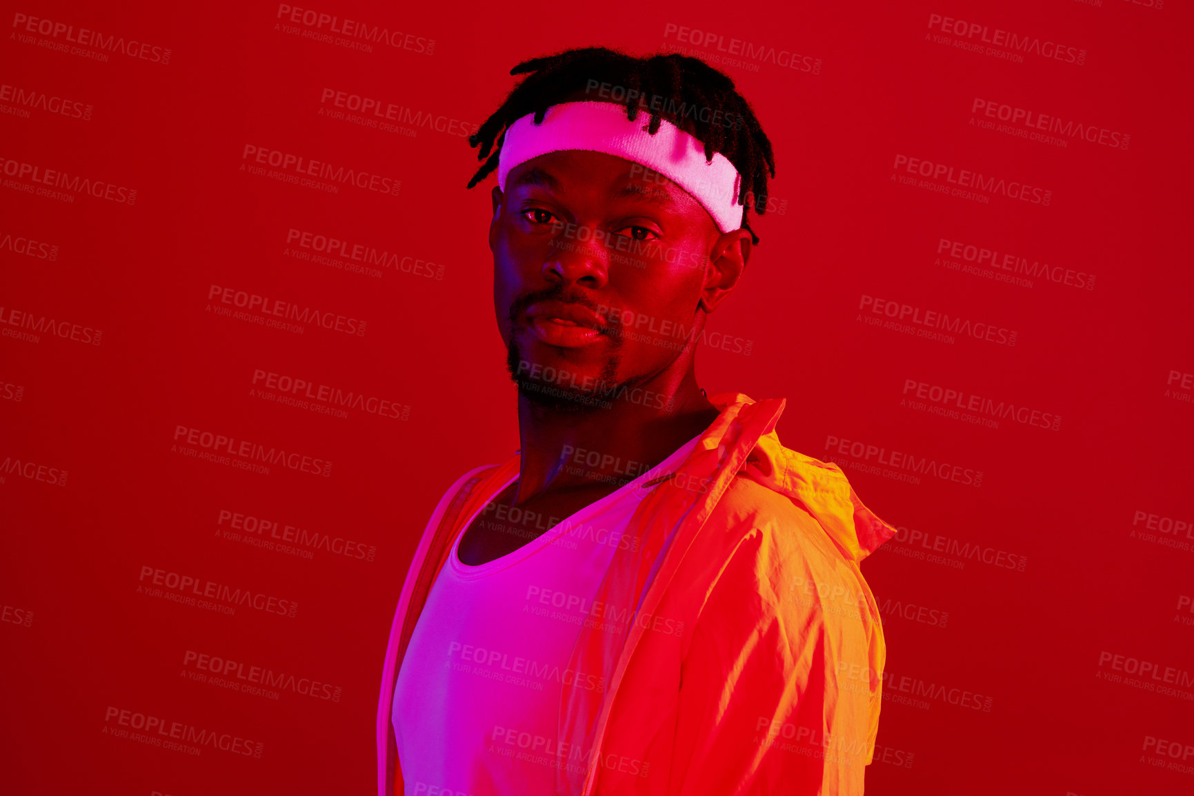 Buy stock photo Sports, portrait and black man in studio for fitness, confidence or ready for wellness training. Male person, dreadlocks model and athlete with pride by red background, light filter or neon aesthetic