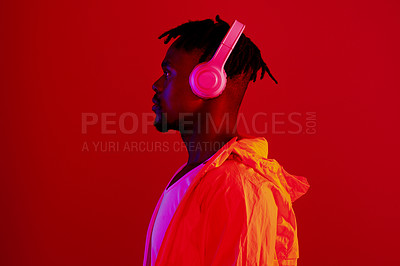 Buy stock photo Headphones, neon fashion and black man profile with music and online song streaming. Internet radio, web audio and African male model with red background in a studio with gen z style and clothing
