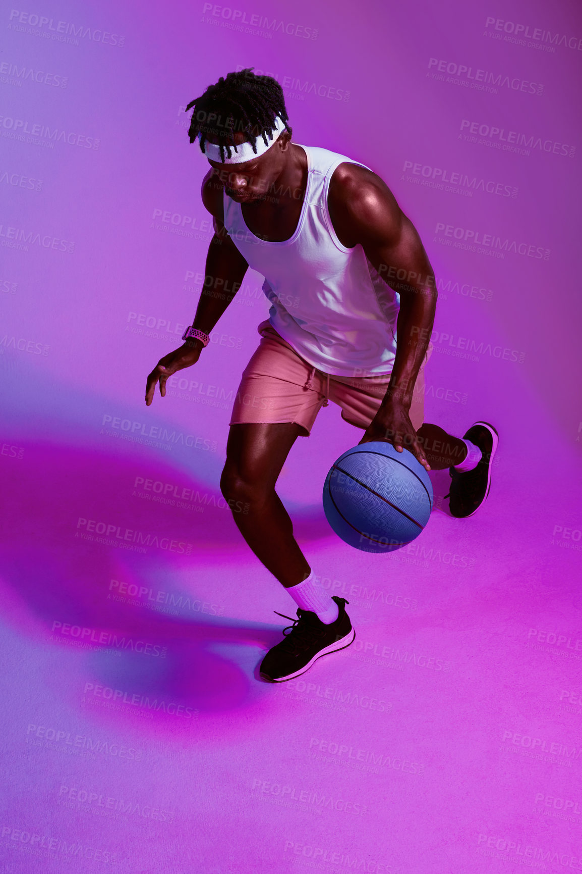 Buy stock photo Basketball, black man and playing in studio for sports, fitness or wellness training for game competition. Male player, professional and athlete with ball by isolated background, neon light or bounce