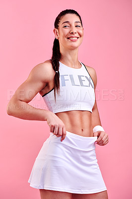 Buy stock photo Studio shot of a sporty young woman posing against a pink background