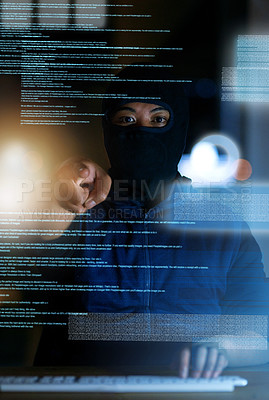 Buy stock photo Shot of a hacker cracking a computer code in the dark