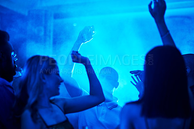 Buy stock photo People dancing in a nightclub, crowd at a party listening to disco or social celebration of new years eve in Las Vegas. Music festival event, celebrate a night out together or techno lighting at rave
