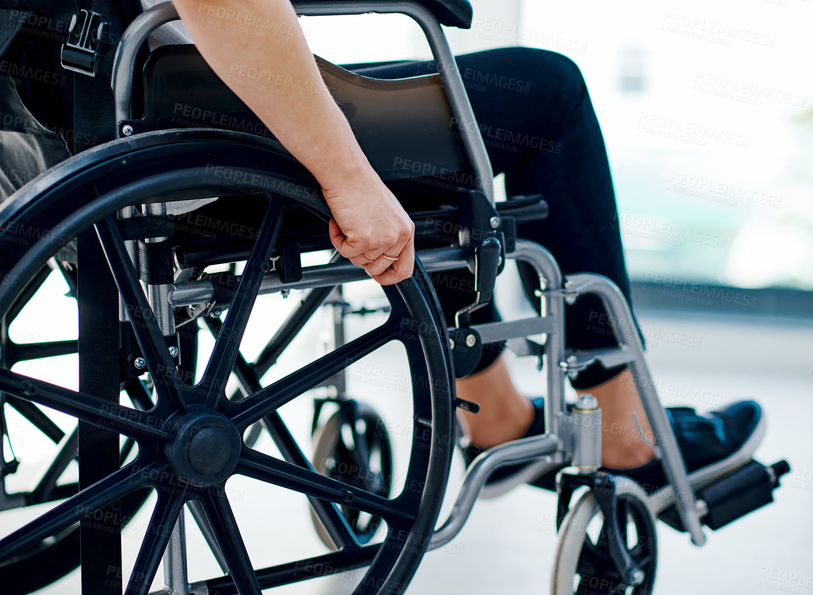 Buy stock photo Cropped shot of an unrecognizable woman sitting in a wheelchair