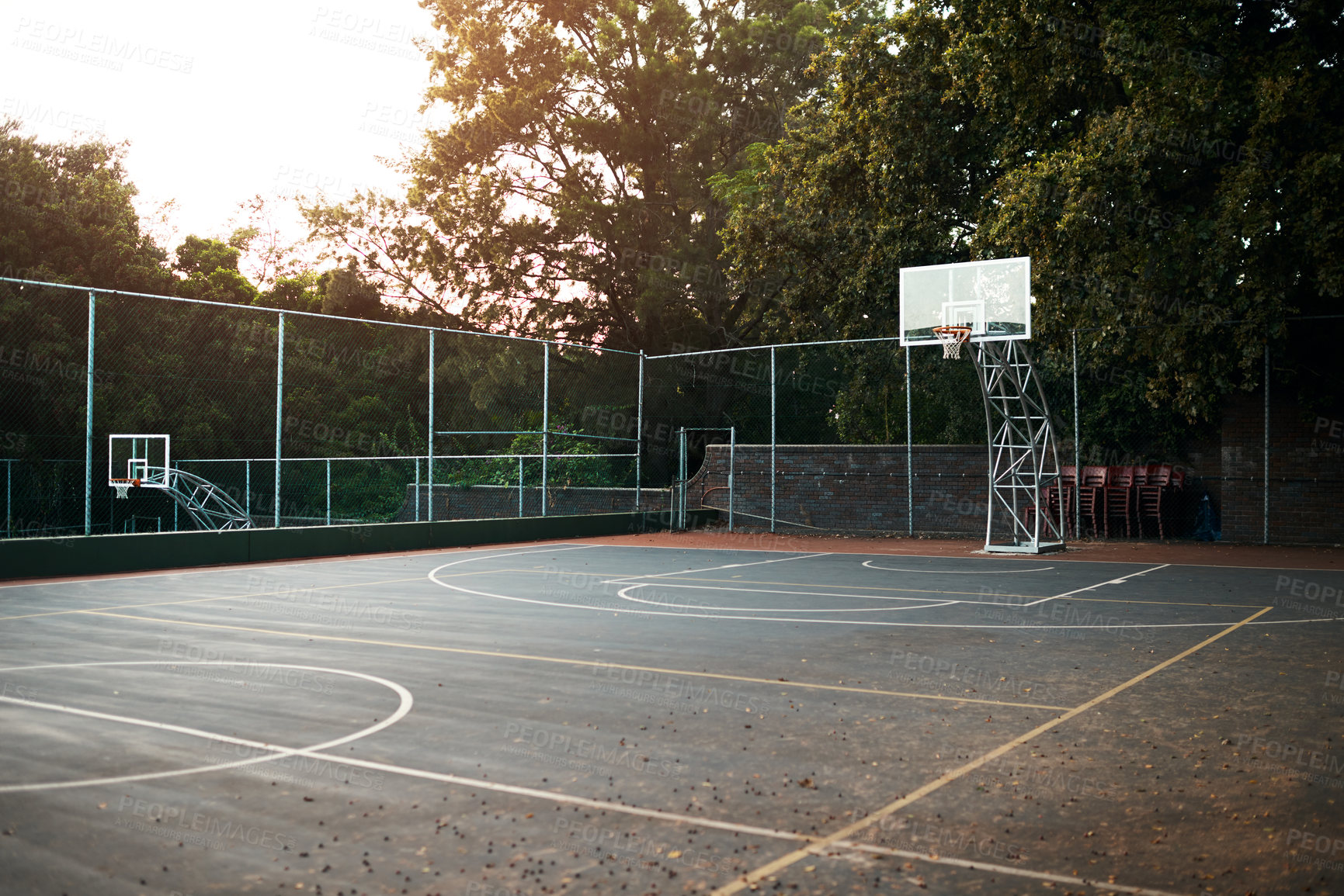 Buy stock photo Cropped shot of an empty basketball court after a match during the day