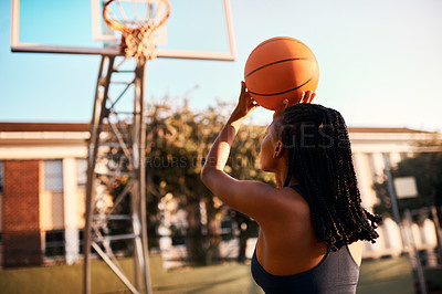 Buy stock photo Full length shot of an unrecognizable sportswoman playing basketball alone during the day