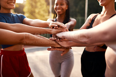 Buy stock photo Cropped shot of an unrecognizable group of sportswomen piling their hands together before a basketball game