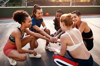 Buy stock photo Cropped shot of a diverse group of sportswomen piling their hands together before playing basketball during the day