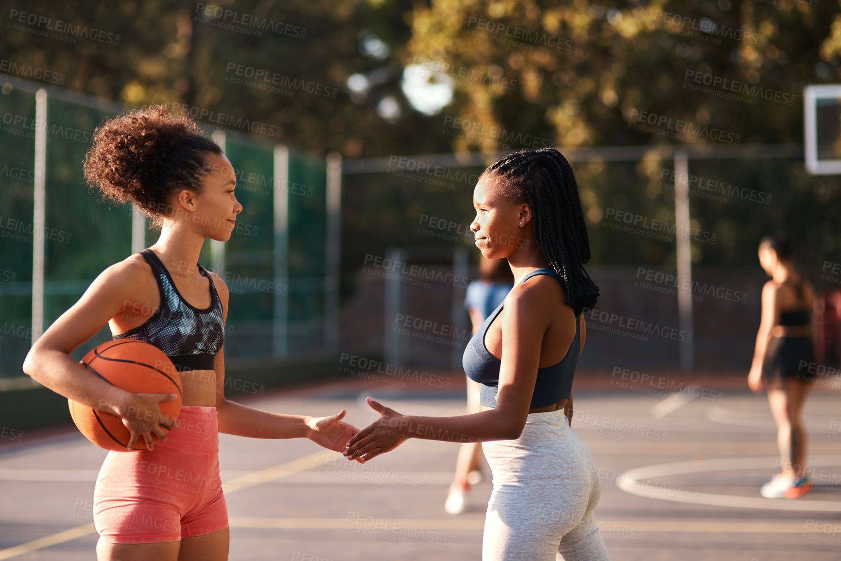 Buy stock photo Low angle shot of a diverse group of friends huddled together before playing basketball during the day