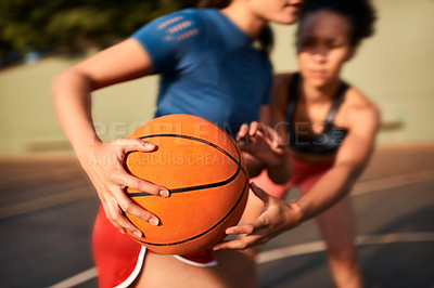 Buy stock photo Cropped shot of an unrecognizable sportswoman holding the basketball away from her opponent during the game
