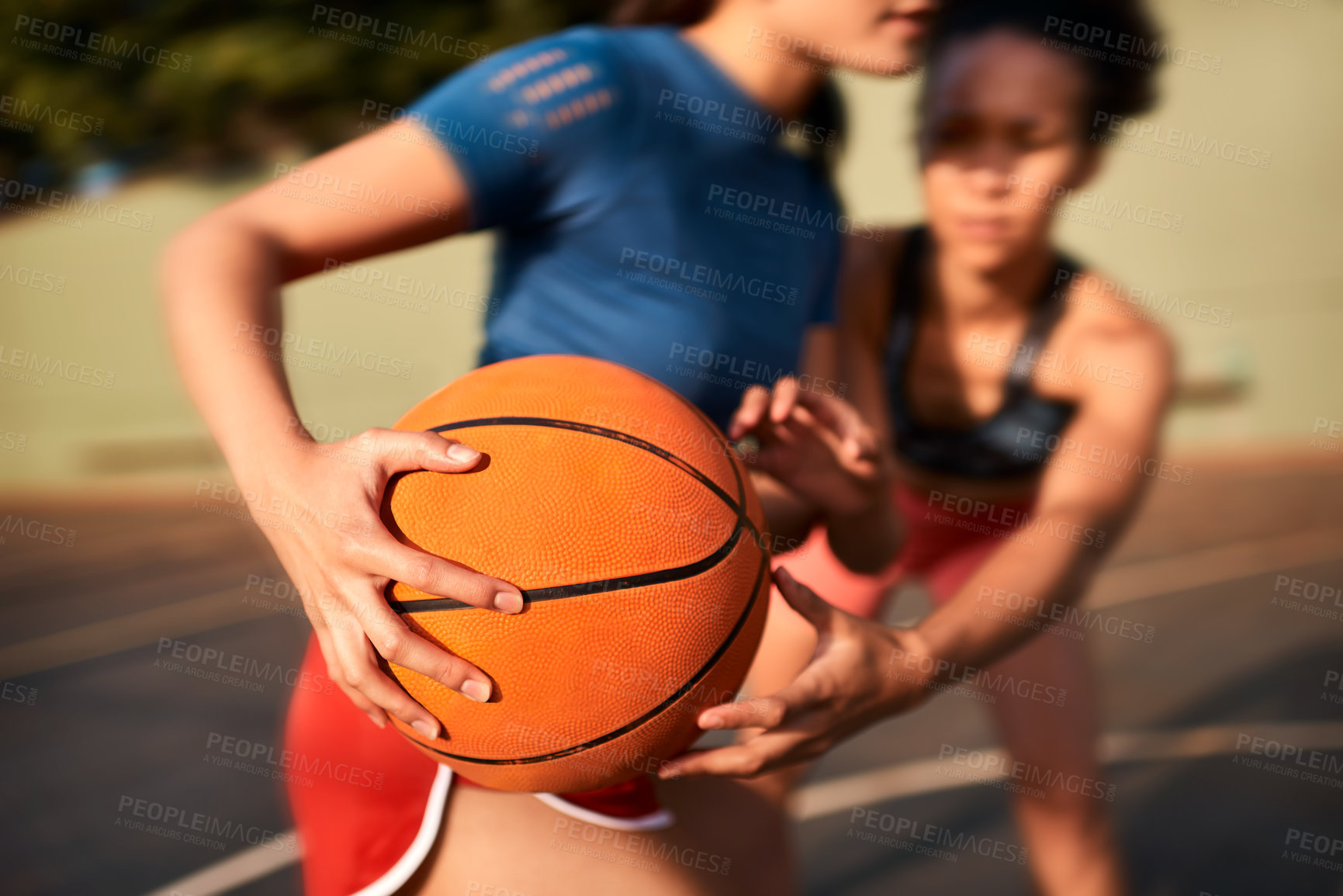 Buy stock photo Cropped shot of an unrecognizable sportswoman holding the basketball away from her opponent during the game