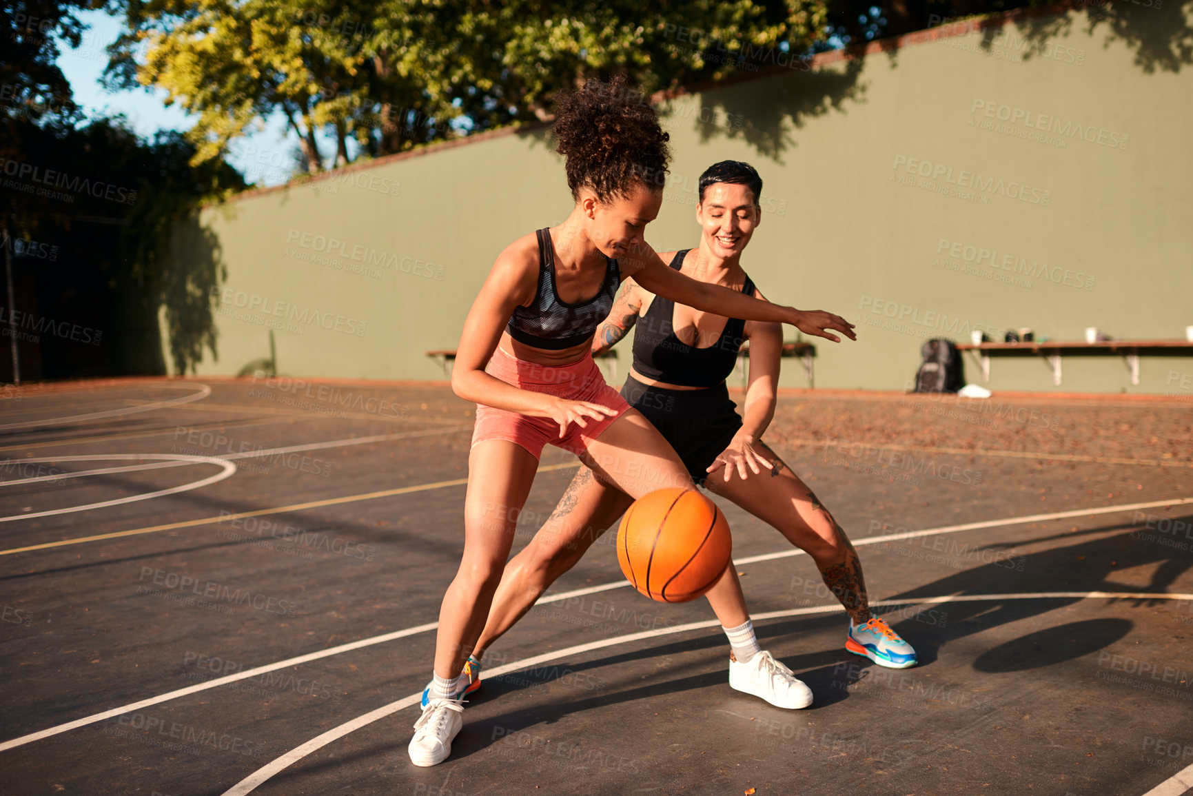 Buy stock photo Fun, basketball and women playing game together for competition, challenge and fitness on playground. Outdoor, performance and girl friends on court with ball, exercise and teamwork at sports club.