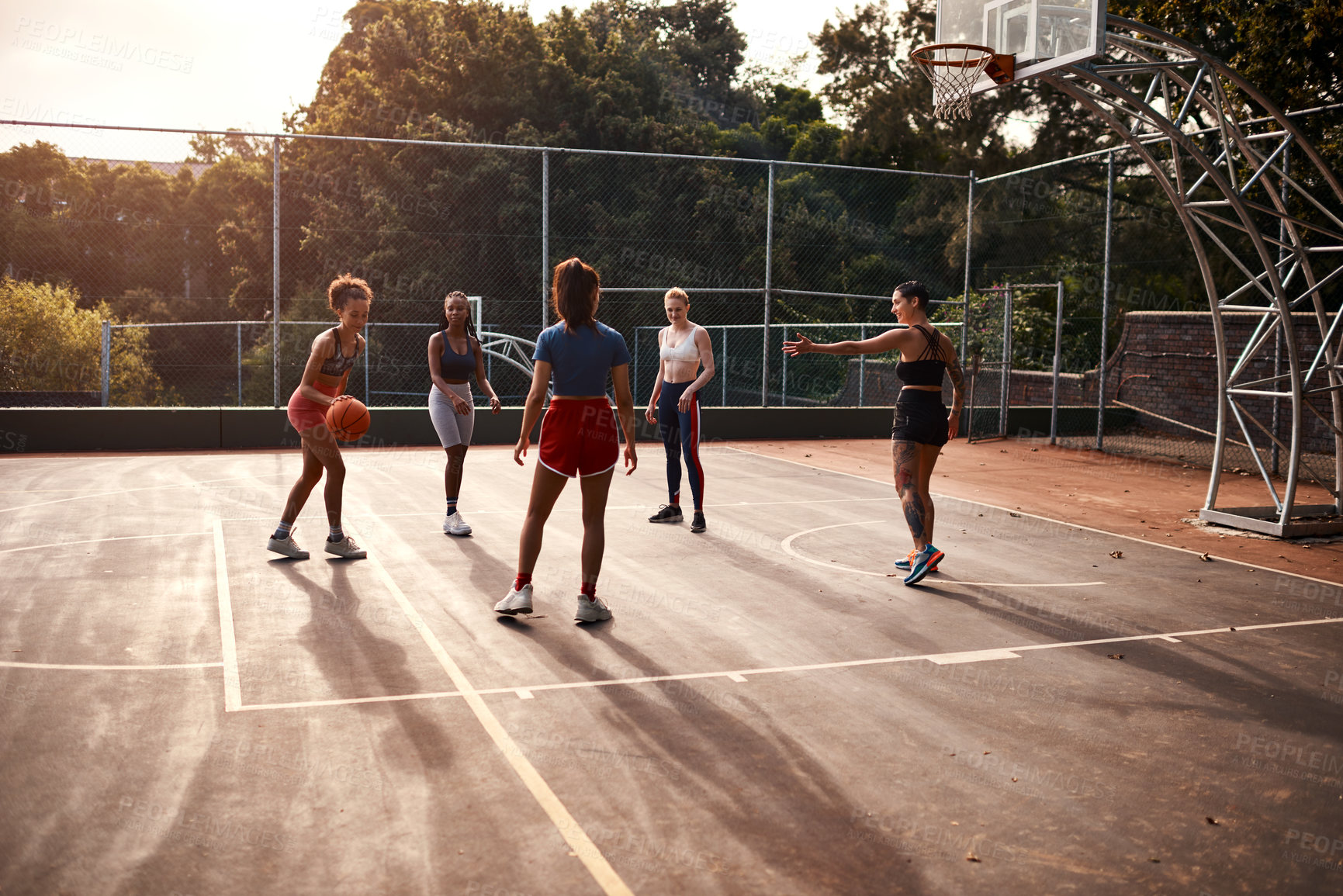 Buy stock photo Basketball, game and outdoor playing with people, fitness and group diversity for competition. Team, women and court for sport practice or friendly match, training and athletes for tournament at club