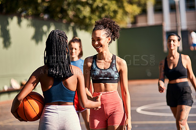 Buy stock photo Low angle shot of a diverse group of friends huddled together after playing basketball during the day