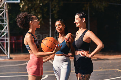 Buy stock photo Cropped shot of a diverse group of sportswomen bonding after a basketball game together during the day