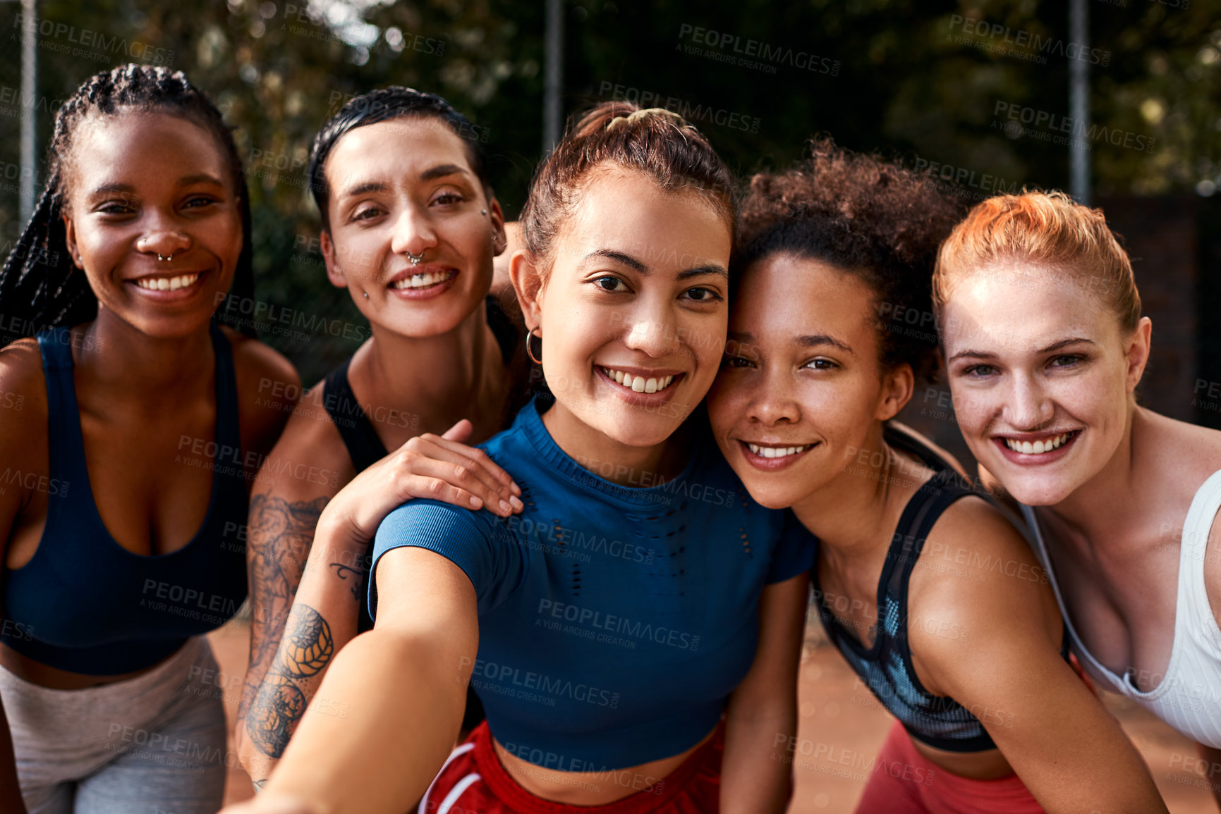 Buy stock photo Cropped shot of a diverse group of sportswomen bonding after a basketball game together during the day