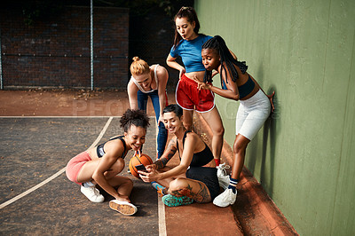 Buy stock photo Cropped shot of a diverse group of sportswomen sitting together for a selfie after a basketball game during the day