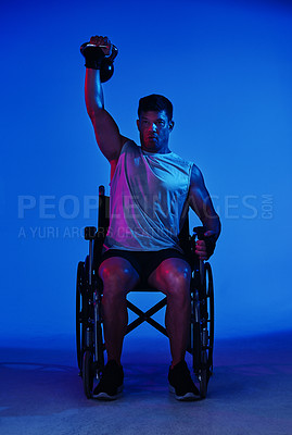 Buy stock photo Blue filtered shot of a man exercising while sitting in his wheelchair
