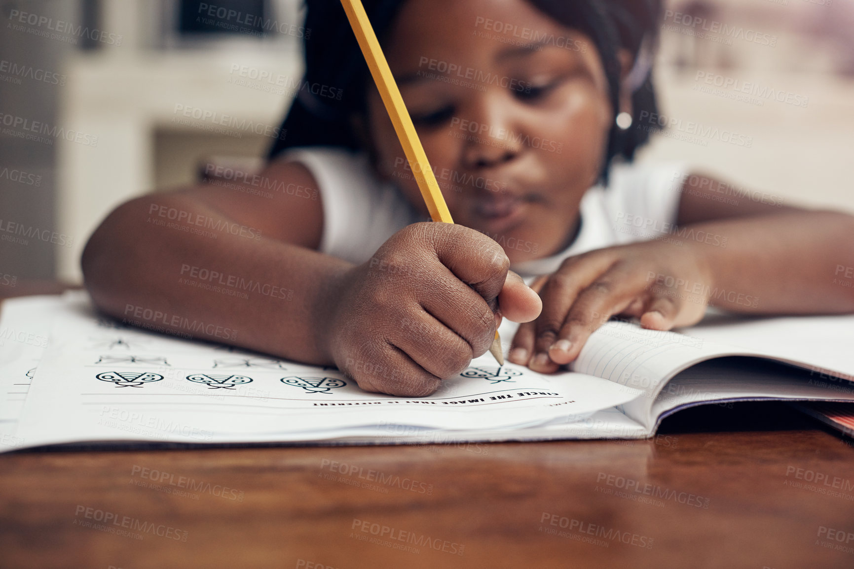 Buy stock photo Cropped shot of an adorable little girl drawing in her drawing book at home