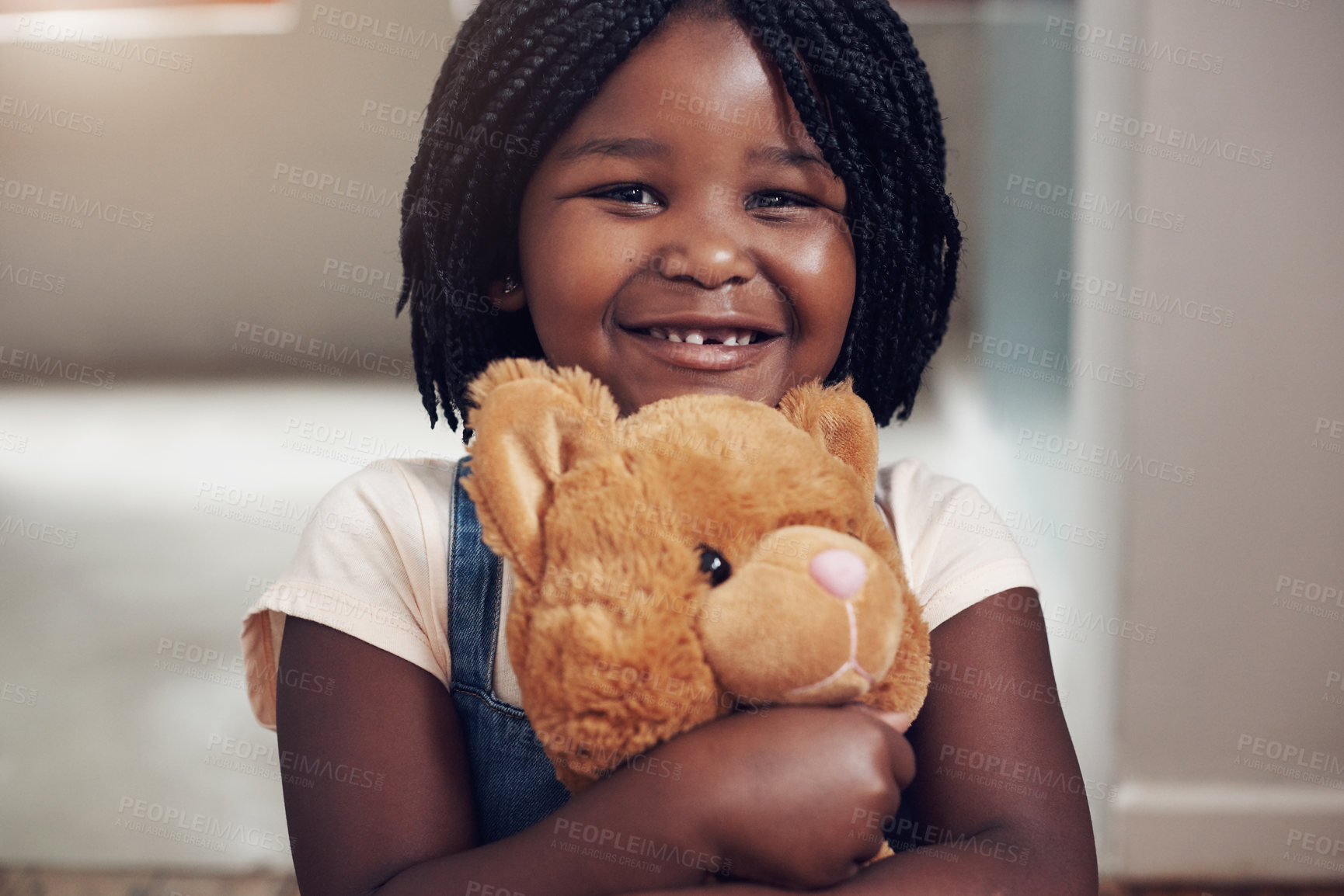 Buy stock photo Portrait of an adorable little girl holding her teddy bear at home